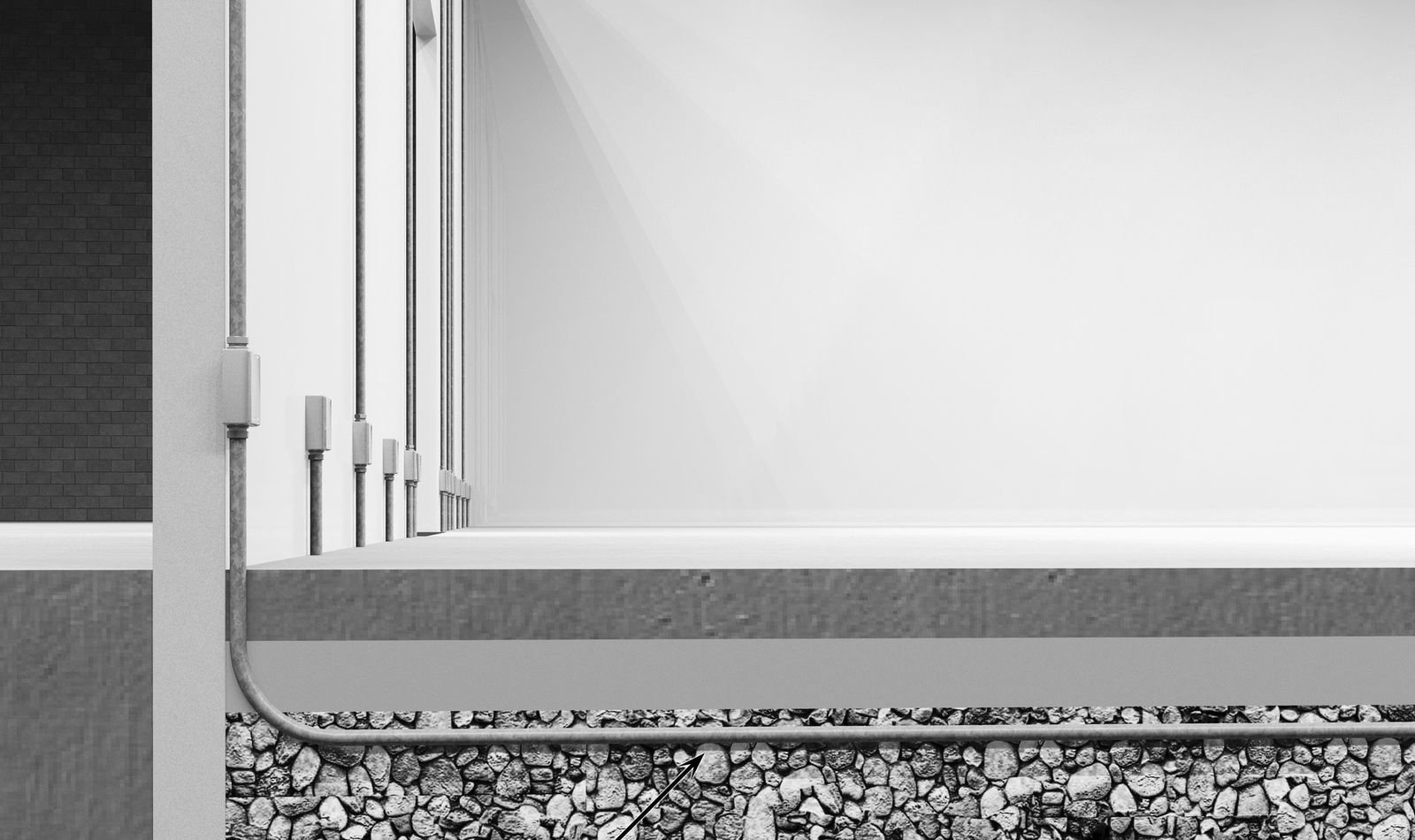 Section view of a rigid conduit rising from the aggregate base up the freezer wall to a junction box