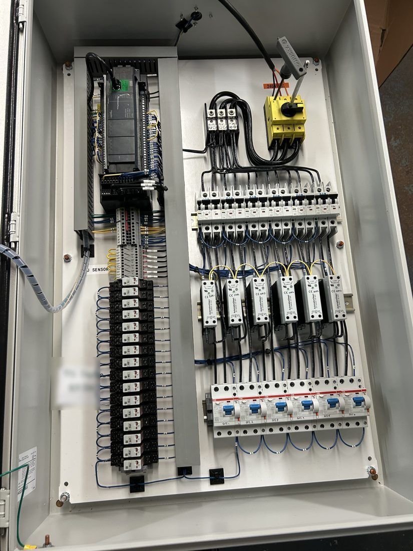 Interior of a freezer floor control panel with PLC, breakers and solid-state relays