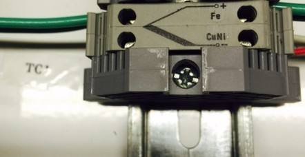 Thermocouple terminal block marked Fe plus and CuNi minus